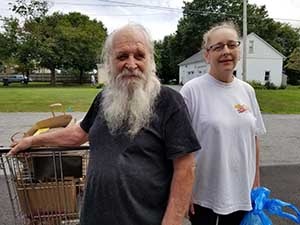 Friend, Inc. Community Services food pantry client Clarence with daughter Tammy and a shopping cart full of food